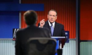 Huckabee talking directly to monitors during the GOP Debate. Photo Source: Doug Mills/New York Times 