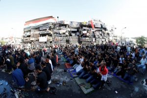 Muslims in prayer in Baghdad to end the month long fasting during the holy holiday of Ramadan. The prayers are being held on the site where a suicide bombing attack recently destroyed a huge swath of the downtown shopping area.