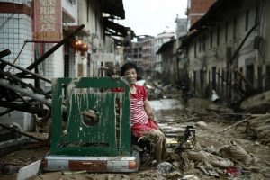 A Chinese woman sits among the ruins of her life as Typhoon Nepartak roared through much of China last week leaving havoc and devastation in its wake.