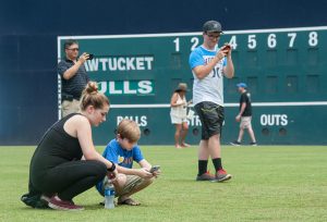 People play "Pokemon Go" on the field at Durham Bulls Athletic Park in Durham, NC. (Kaitlin McKeown/The Herald-Sun via AP)