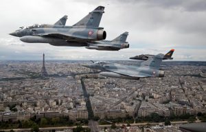French Mirage fighter jets fly over Paris on their way to an air show in celebration of France's national holiday, Bastille Day on July 14.