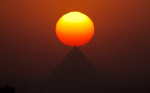 A breathtaking shot of a sunset over the pyramids of Giza in Egypt.