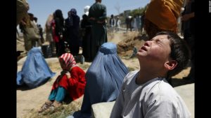 A young boy mourns the death of his sister at her funeral in Kabul,Afghanistan. His sister was murdered by being tortured and then set on fire by her husband's family because they felt that there were marriage promises not kept. The girl was 14 and pregnant.