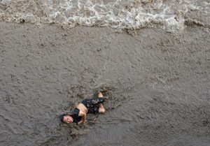 A powerful typhoon continues to besiege southern China and Hong Kong. This man was thrown from a bridge by a gigantic tidal wave and landed in a sea of rushing water and mud.