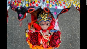 A little child leads a celebration in Bangladesh in honor of the birthday of the great Hindu god, Krishna.