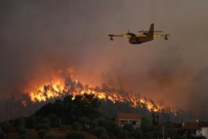 A water tanker plane heads toward the massive wildfires that have been raging throughout Portugal.