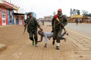 Soldiers of the army of the African nation of the Congo take care of a protester. Protests have been waged recently as the citizenry seeks to stop the government from murdering people.