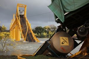 A bridge collapsed over a river in Chile causing a huge tanker freight train to crash into the raging river.