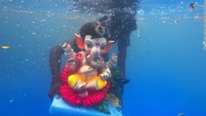 The Hindu goddesses Ganesha lay submerged in a pond during a celebration in Mumbai. For Hindus, if one prays to the goddesses Ganesha, all obstacles will be removed from your life.