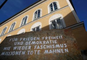 The imposing htree story yellow house where Hitler was born has an engraved stone marker out front that reads: "For peace, freedom, and democracy, never again fascism, millions of dead are a warning."